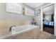 Bright bathroom featuring a soaking tub with tile surround at 687 Saranac Dr, Winter Springs, FL 32708