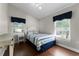 Cozy bedroom boasts natural light and a comfortable bed with blue accents and wood flooring at 687 Saranac Dr, Winter Springs, FL 32708