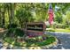 Chelsea Woods brick sign with manicured landscape, complemented by an American flag at 687 Saranac Dr, Winter Springs, FL 32708