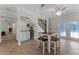 Charming dining area with table set and a staircase with wooden banister adjacent a modern beverage fridge at 687 Saranac Dr, Winter Springs, FL 32708