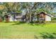 Classic home with manicured lawn, brick details, mature trees, and lots of curb appeal at 687 Saranac Dr, Winter Springs, FL 32708