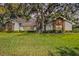 Charming single-story home featuring a lush front yard with mature landscaping and a welcoming facade at 687 Saranac Dr, Winter Springs, FL 32708