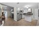 Open kitchen with stainless steel appliances, island, and seamless flow to the living area at 687 Saranac Dr, Winter Springs, FL 32708