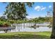 Scenic lake featuring a boat dock and serene water views at 687 Saranac Dr, Winter Springs, FL 32708