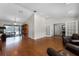 Spacious living room featuring wood floors, large windows, and access to outdoor spaces at 687 Saranac Dr, Winter Springs, FL 32708