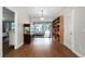 Living area with wood flooring and adjacent screened in porch and a bookshelf at 687 Saranac Dr, Winter Springs, FL 32708