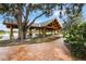 A beautiful wooden pavilion with a metal roof, picnic tables, and stone columns, perfect for gatherings at 687 Saranac Dr, Winter Springs, FL 32708