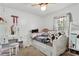 Bright bedroom featuring a white daybed with plush pillows and a vanity at 745 Oak Ln, Orange City, FL 32763