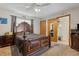 Bedroom features a dark wood furniture set, ceiling fan and ensuite bathroom with a walk-in closet at 745 Oak Ln, Orange City, FL 32763