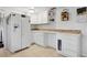 Bright kitchen features white cabinets, tile countertops, and a modern refrigerator at 745 Oak Ln, Orange City, FL 32763