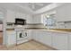 Bright kitchen with white cabinets, tile backsplash, and a view from the window at 745 Oak Ln, Orange City, FL 32763