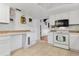 Well-lit kitchen featuring white cabinets, tile backsplash, and modern appliances at 745 Oak Ln, Orange City, FL 32763