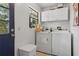 Bright laundry room with a washer, dryer, and ample storage space at 745 Oak Ln, Orange City, FL 32763