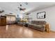 Open-concept living room featuring laminate flooring, comfortable seating, and abundant natural light at 745 Oak Ln, Orange City, FL 32763