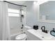 Well-lit bathroom featuring a shower-tub combination and modern fixtures at 7803 Laurel Oak Ln, Kissimmee, FL 34747
