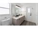 Bright bathroom with double sinks, modern fixtures, and natural light from the window at 7803 Laurel Oak Ln, Kissimmee, FL 34747