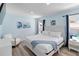 Calming bedroom with light blue walls, white furniture, and natural light at 7803 Laurel Oak Ln, Kissimmee, FL 34747