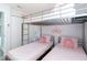 Inviting bedroom with bunk beds, soft pink accents, and closet at 7803 Laurel Oak Ln, Kissimmee, FL 34747