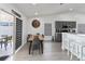 Open dining area with natural light, modern furnishings, and a view of the outdoor space at 7803 Laurel Oak Ln, Kissimmee, FL 34747