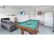 Finished garage featuring a pool table, movie poster, and mini fridge at 7803 Laurel Oak Ln, Kissimmee, FL 34747