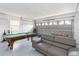 Finished garage with a pool table, foosball table, and a comfortable couch at 7803 Laurel Oak Ln, Kissimmee, FL 34747