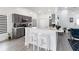 Stylish kitchen with gray cabinetry, stainless steel appliances, breakfast bar, and modern finishes at 7803 Laurel Oak Ln, Kissimmee, FL 34747