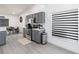 Modern kitchen features gray cabinets, stainless steel appliances, and bright, airy windows at 7803 Laurel Oak Ln, Kissimmee, FL 34747