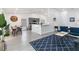 Bright open living space featuring gray cabinets, light floors, breakfast bar, and dining area at 7803 Laurel Oak Ln, Kissimmee, FL 34747