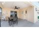 Screened patio with a ceiling fan, dining table, and access to the pool area at 7803 Laurel Oak Ln, Kissimmee, FL 34747
