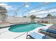Enclosed backyard pool area with lounge chairs and a privacy fence at 7803 Laurel Oak Ln, Kissimmee, FL 34747