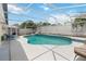 Enclosed pool area with comfortable lounge chairs, and a barbecue setup at 7803 Laurel Oak Ln, Kissimmee, FL 34747