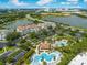 Stunning aerial view showcasing the community pool, lush landscaping, serene lake, and surrounding cityscape at 8001 Cool Breeze Dr # 118, Orlando, FL 32819