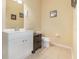 This bathroom has a single sink vanity, a toilet, tiled floors, and pale yellow walls at 8001 Cool Breeze Dr # 118, Orlando, FL 32819