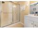 Bathroom featuring a single sink vanity and a glass door shower over tub at 8001 Cool Breeze Dr # 118, Orlando, FL 32819