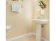 Pedestal sink in a bathroom with a neutral colored wall and white trim at 8001 Cool Breeze Dr # 118, Orlando, FL 32819