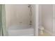 Bathroom with white tiled shower and tub and white toilet in the corner at 8001 Cool Breeze Dr # 118, Orlando, FL 32819