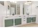 Bright bathroom featuring a double sink vanity, green cabinets and neutral colored tile flooring at 8001 Cool Breeze Dr # 118, Orlando, FL 32819