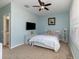 This bedroom has light blue walls, carpet flooring, a ceiling fan, and light colored shelving at 8001 Cool Breeze Dr # 118, Orlando, FL 32819