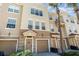 Inviting townhome with neutral tones, a well-manicured lawn and beautiful palm trees offering a warm curb appeal at 8001 Cool Breeze Dr # 118, Orlando, FL 32819
