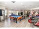 Community game room featuring two pool tables, arcade games, and light wood floors at 8001 Cool Breeze Dr # 118, Orlando, FL 32819