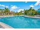 Community pool with lounge chairs, umbrellas, and lush landscaping, perfect for relaxing at 8001 Cool Breeze Dr # 118, Orlando, FL 32819