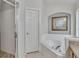 Bathroom features a glass-enclosed shower and a corner soaking tub for added relaxation and comfort at 8471 Secret Key Cv, Kissimmee, FL 34747