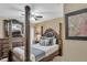 Bedroom featuring a four-poster bed, dresser with large mirror and ceiling fan at 8471 Secret Key Cv, Kissimmee, FL 34747
