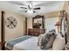 Bedroom featuring a four-poster bed, dresser with large mirror and ceiling fan at 8471 Secret Key Cv, Kissimmee, FL 34747