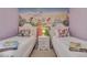 Whimsical ' bedroom featuring two twin beds with colorful princess-themed decor and a bright mural at 8471 Secret Key Cv, Kissimmee, FL 34747