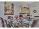 Bright dining area featuring a glass table, seating for six, and adjacent access to the kitchen at 8471 Secret Key Cv, Kissimmee, FL 34747