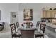 Stylish dining area featuring a glass table, seating for six, and seamless access to the kitchen at 8471 Secret Key Cv, Kissimmee, FL 34747