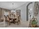 Elegant dining room with decorative chandelier and space for six, great for Gathering meals and entertaining at 8471 Secret Key Cv, Kissimmee, FL 34747