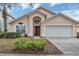 Charming single Gathering home featuring a two-car garage, well-maintained landscaping, and a lovely front entrance at 8471 Secret Key Cv, Kissimmee, FL 34747