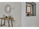 Hallway with a rustic wooden table with mirror and decorative accessories, complemented by neutral wall colors at 8471 Secret Key Cv, Kissimmee, FL 34747